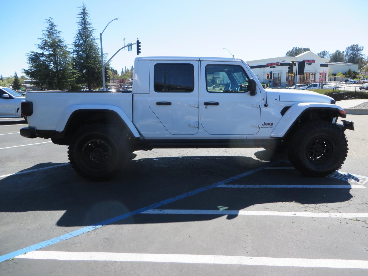 2021 White /Black Jeep Gladiator Mojave (1C6JJTEG5ML) with an 3.6L V6 DOHC 24V engine, automatic transmission, located at 2630 Grass Valley Highway, Auburn, CA, 95603, (530) 508-5100, 38.937893, -121.095482 - Mojave Edition Gladiator with 17" KMC wheels, 37" Cooper STT Pro tires, front bumper, Badlands winch, removable front license plate, and rock sliders. - Photo#3